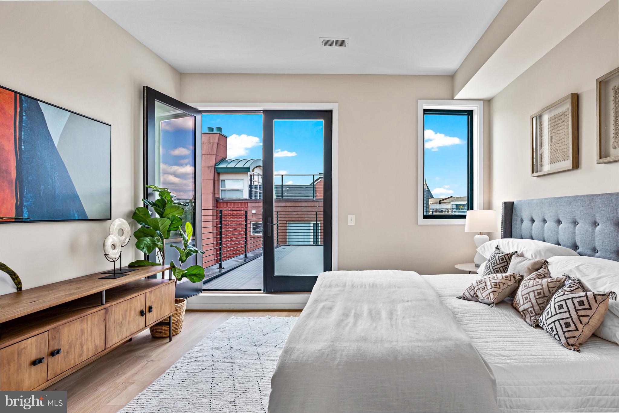 1402 12th Street Northwest, Unit 10 Washington, DC 20005 - Photo 28 of 38 a bedroom with a large bed and large windows