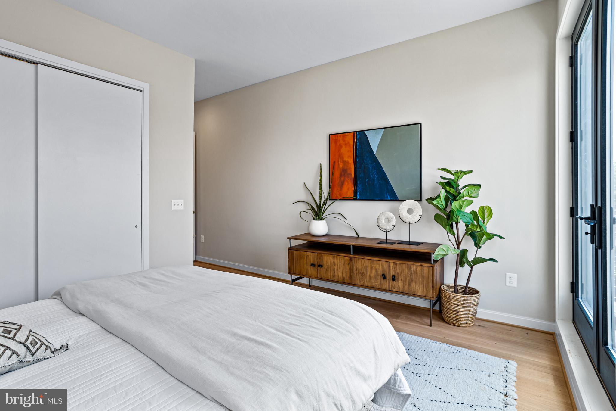 1402 12th Street Northwest, Unit 10 Washington, DC 20005 - Photo 29 of 38 a bedroom with a bed and a potted plant
