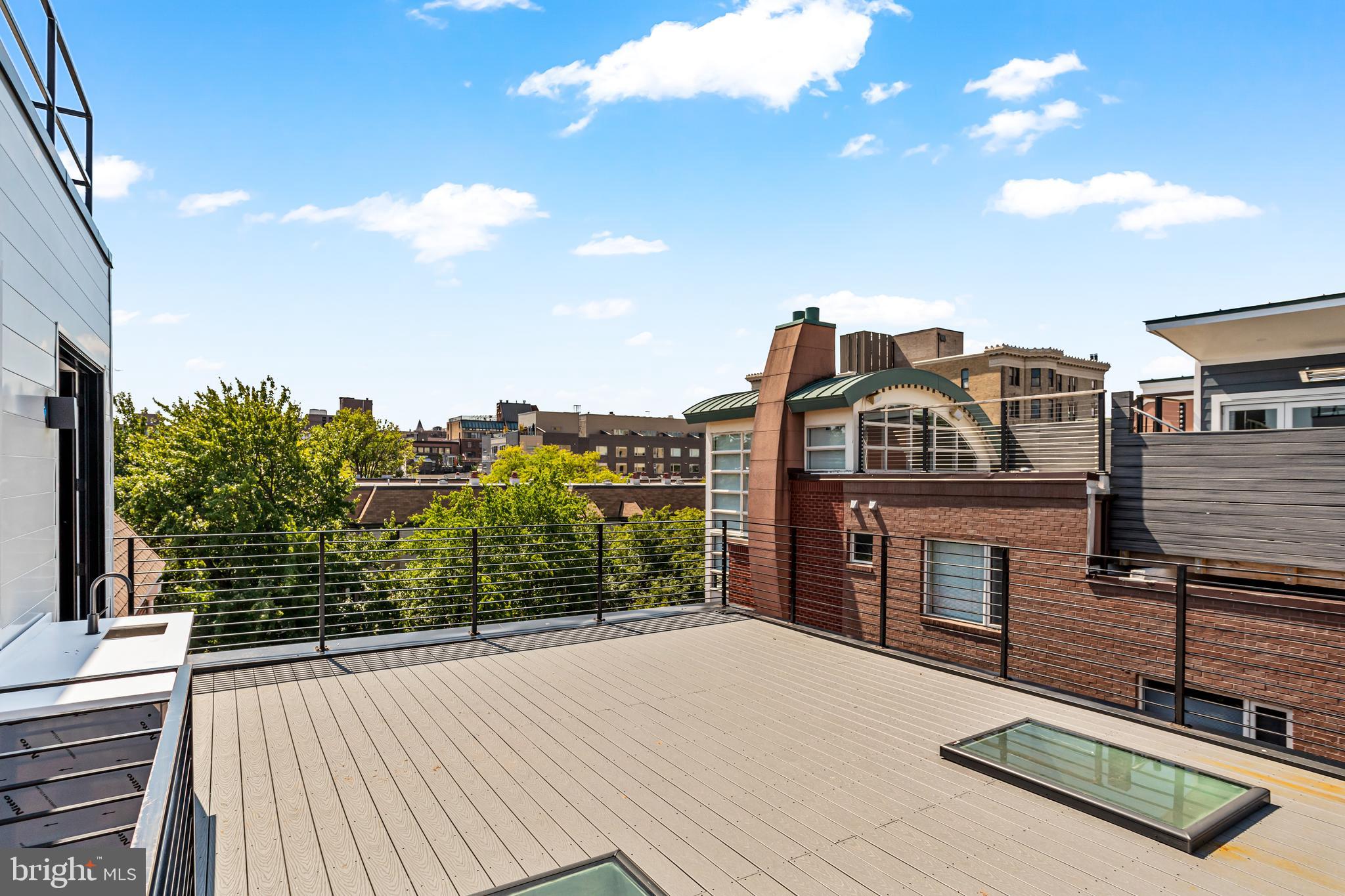 1402 12th Street Northwest, Unit 10 Washington, DC 20005 - Photo 36 of 38 a view of a house with a roof deck