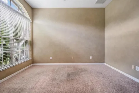 a spacious bedroom with a bed and a ceiling fan