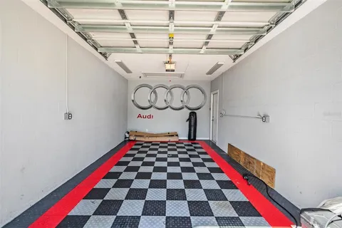 an aerial view of residential houses with outdoor space and lake view