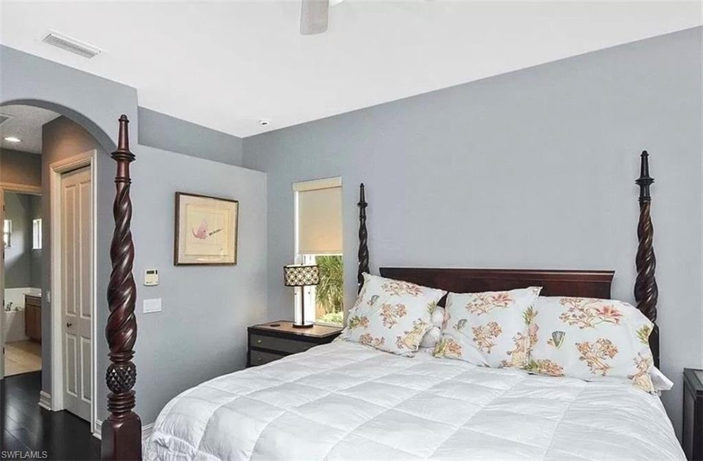 6044 Dogleg Drive Naples, FL 34113 - Photo 15 of 21 a bedroom with a bed and a window