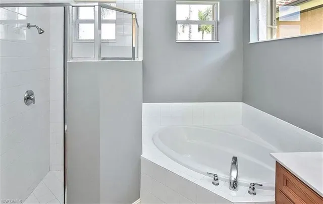 a white bath tub sitting next to a window