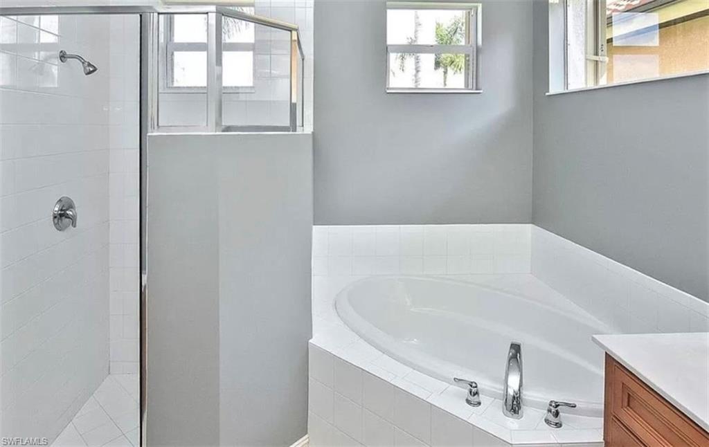 6044 Dogleg Drive Naples, FL 34113 - Photo 18 of 21 a white bath tub sitting next to a window