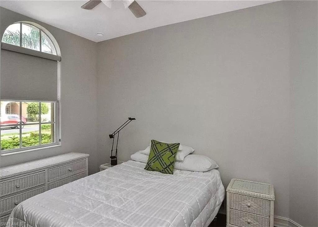 6044 Dogleg Drive Naples, FL 34113 - Photo 19 of 21 a bedroom with a bed and a window