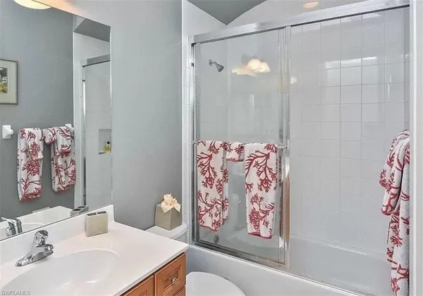 a bathroom with a sink a toilet and a shower curtain