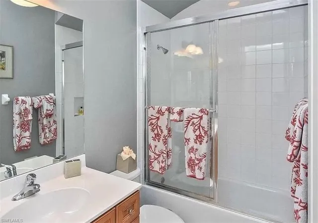 a bathroom with a sink a toilet and a shower curtain