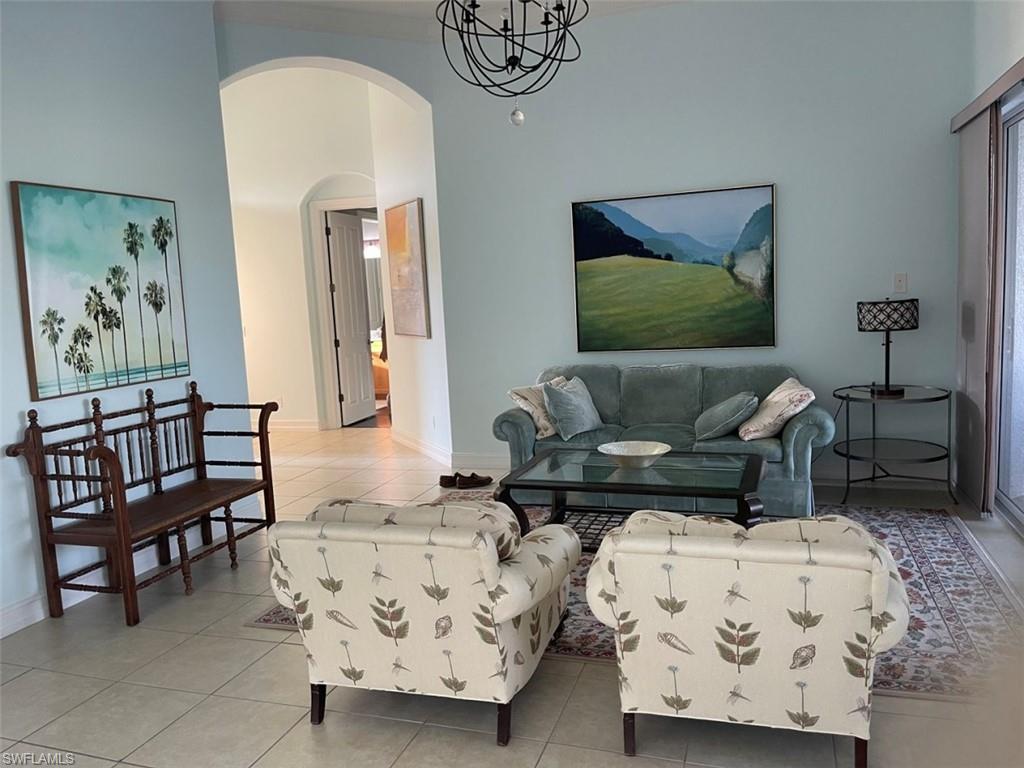 6044 Dogleg Drive Naples, FL 34113 - Photo 8 of 21 a living room with furniture and a painting