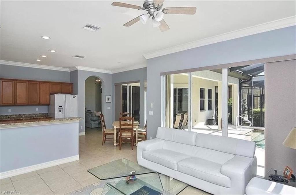 6044 Dogleg Drive Naples, FL 34113 - Photo 10 of 21 a living room with furniture and a large window