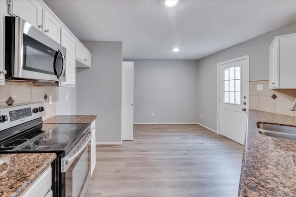 a kitchen with a stove and a microwave