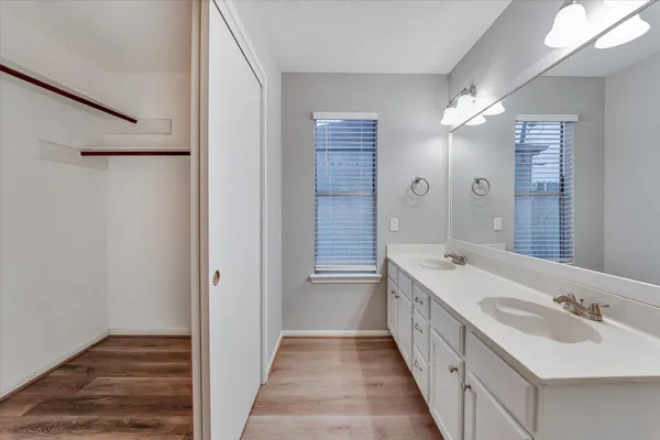a bathroom with a double vanity sink and mirror