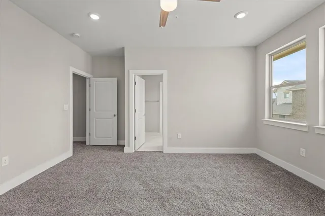an empty room with windows and closet