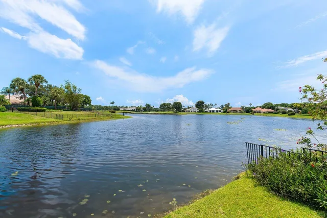 a view of a patio with table and chairs potted plants with wooden floor and fence