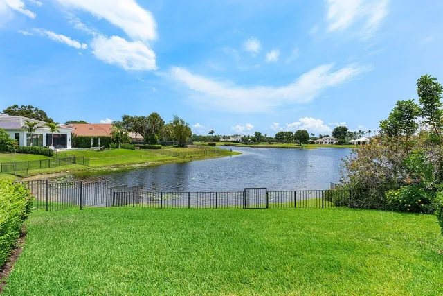 a view of house with swimming pool and yard