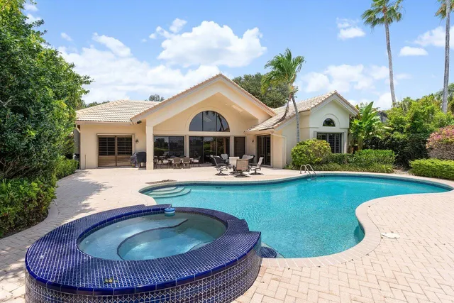 a living room with furniture a rug and a bookshelf