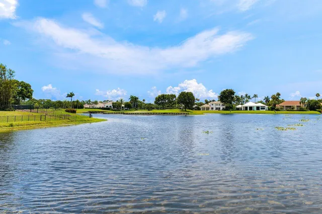 a living room with furniture a large window and a flat tv screen