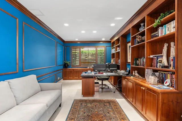 a living room with furniture fireplace and a large window