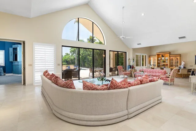 a living room with furniture large window and a flat screen tv