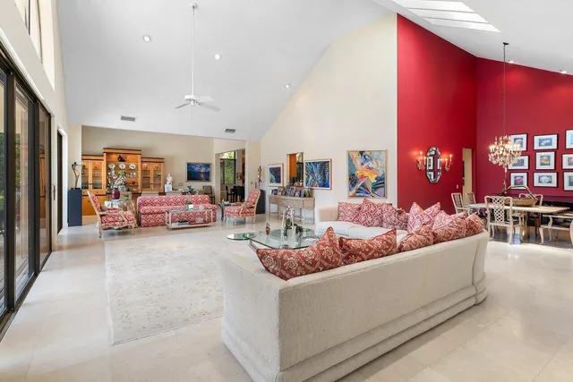 a living room with furniture fireplace and a large window