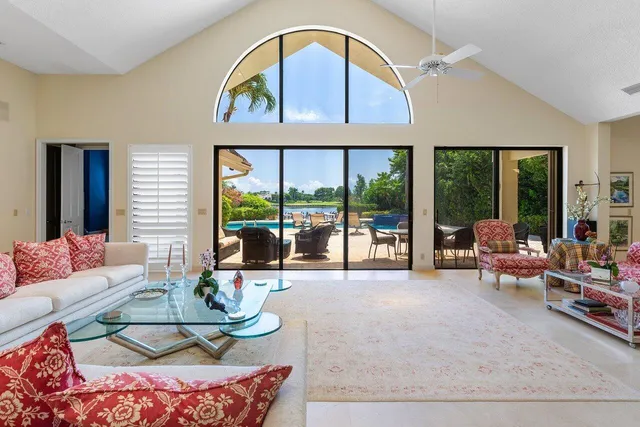 a room with furniture pool table and window
