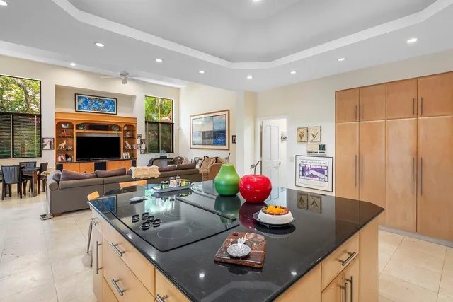 a bathroom with a granite countertop sink a toilet and a mirror