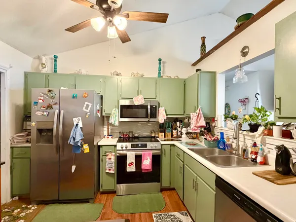 a kitchen that has a lot of cabinets and refrigerator