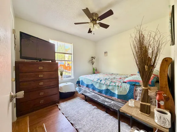a bedroom with a bed and a chandelier