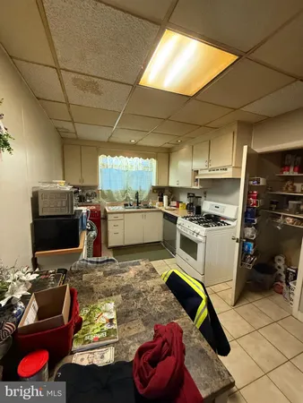 a kitchen with furniture and appliances