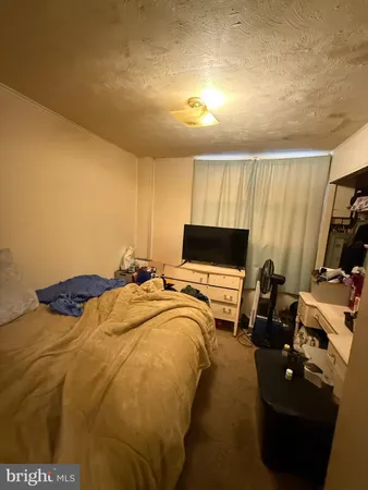a bedroom with bed and flat screen tv