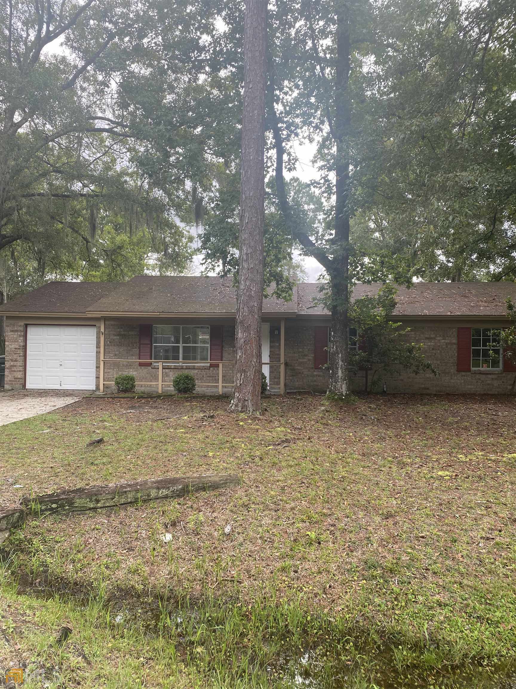 817 Clarks Bluff Road Kingsland, GA 31548 - Photo 1 of 1 a front view of a house with a garden and trees