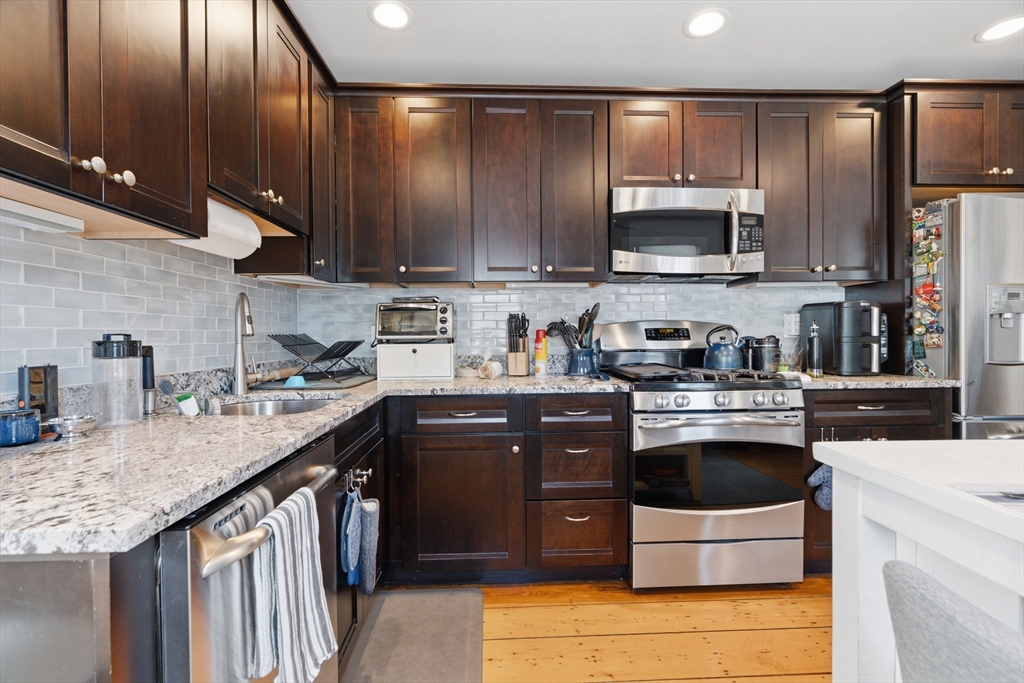 33 Mystic Street, Unit 3 Boston, MA 02129 - Photo 8 of 21 a kitchen with stainless steel appliances granite countertop a sink a stove and a refrigerator