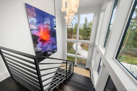 a bedroom with a bed a window and a flat screen television