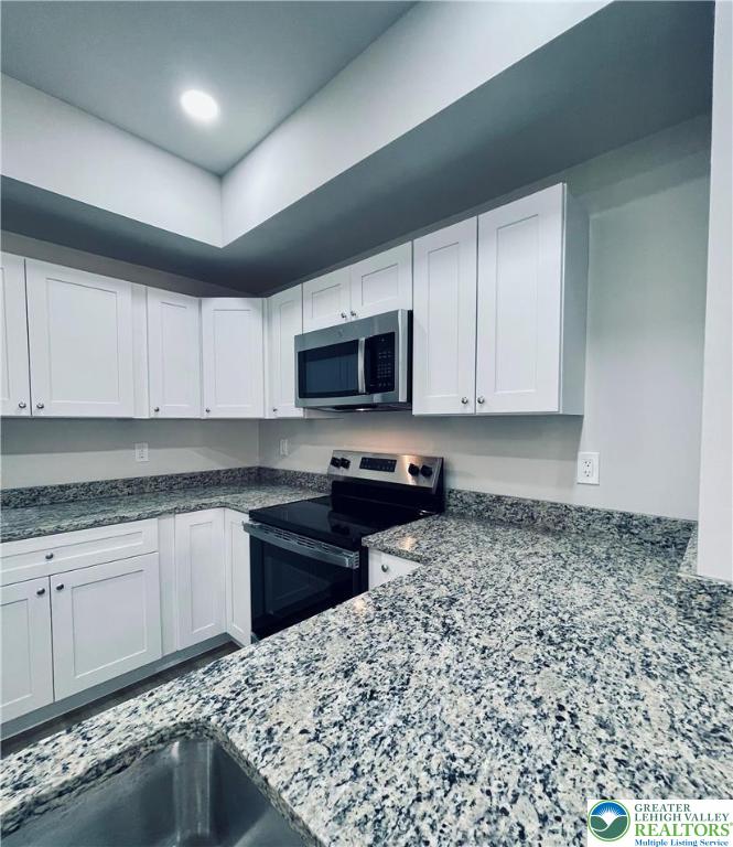 318 Barber Street, Unit LOT 33 Allentown, PA 18103 - Photo 22 of 53 a kitchen with granite countertop a sink and a stove top oven