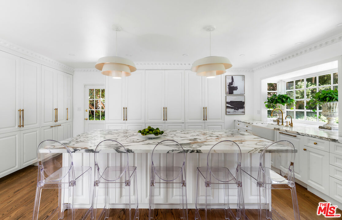 949 Stone Canyon Road Los Angeles, CA 90077 - Photo 14 of 41 a view of a kitchen with granite countertop lots of counter top and dining space