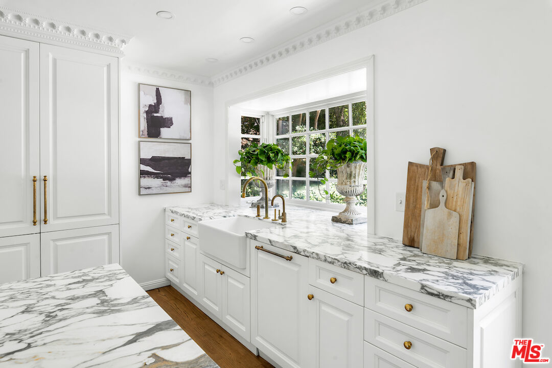 949 Stone Canyon Road Los Angeles, CA 90077 - Photo 16 of 41 a bedroom with a granite countertop sink and a window