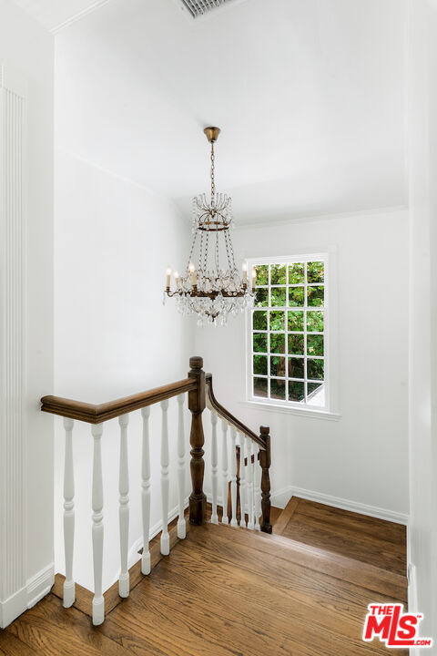 949 Stone Canyon Road Los Angeles, CA 90077 - Photo 19 of 41 a view of a hallway with wooden floor and staircase