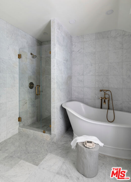 949 Stone Canyon Road Los Angeles, CA 90077 - Photo 25 of 41 a bathroom with a granite countertop tub and a shower