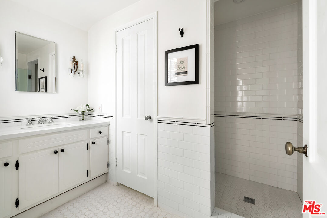 949 Stone Canyon Road Los Angeles, CA 90077 - Photo 29 of 41 a bathroom with a shower sink and mirror