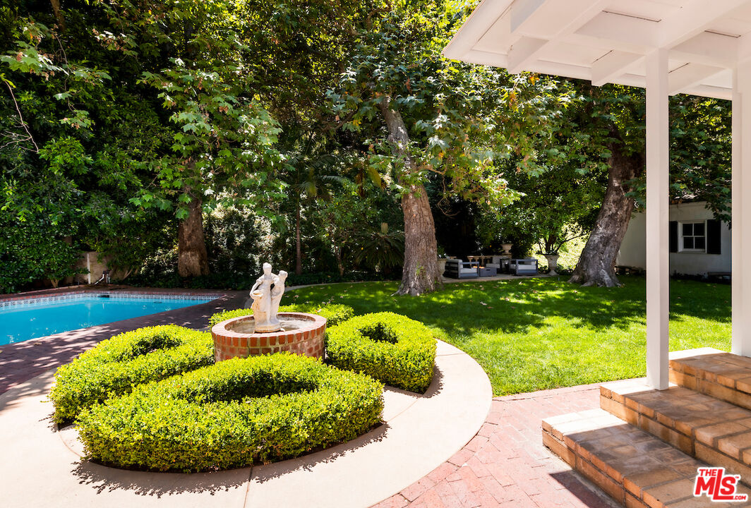 949 Stone Canyon Road Los Angeles, CA 90077 - Photo 39 of 41 a view of a swimming pool with a patio