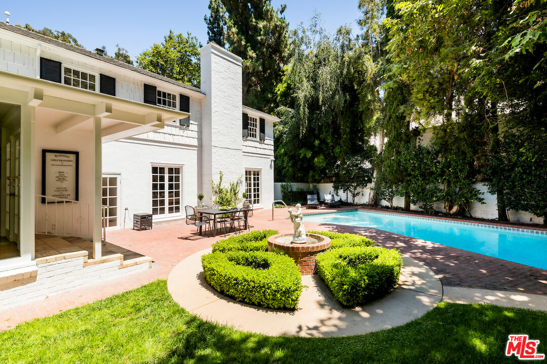 949 Stone Canyon Road Los Angeles, CA 90077 - Photo 41 of 41 a swimming pool with barbeque oven and outdoor seating