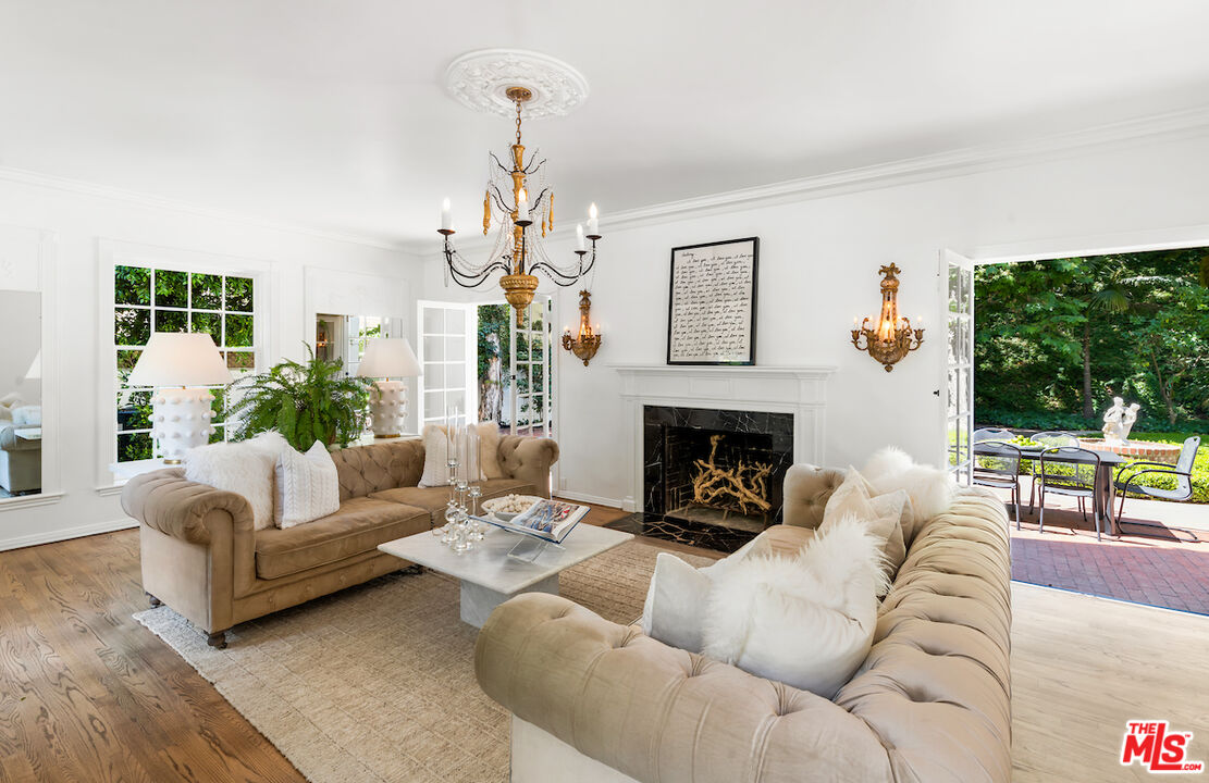 949 Stone Canyon Road Los Angeles, CA 90077 - Photo 9 of 41 a living room with furniture and a fireplace