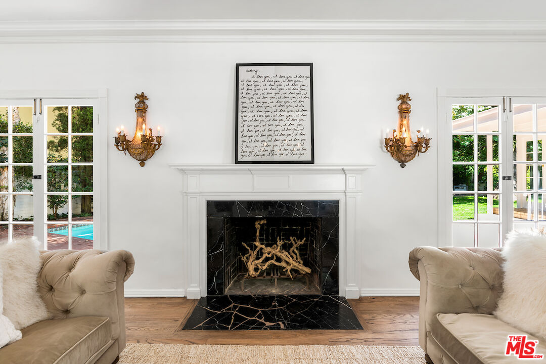 949 Stone Canyon Road Los Angeles, CA 90077 - Photo 10 of 41 a living room with furniture and a fireplace