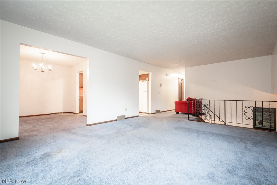 4835 2nd Street Northwest Canton, OH 44708 - Photo 9 of 28 The living room looks into the dining room and kitchen
