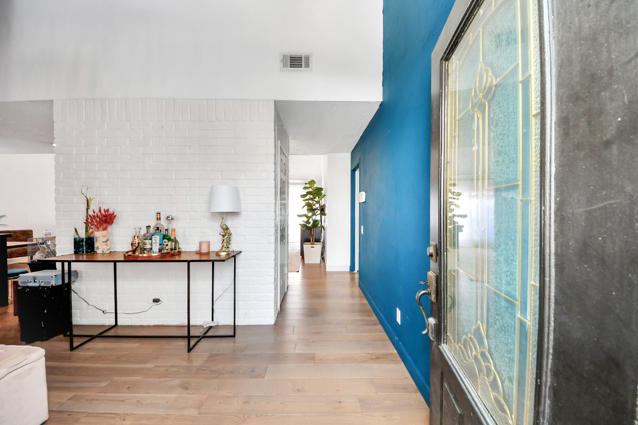 15015 Margeson Street Houston, TX 77084 - Photo 2 of 21 a hallway with a table and chairs