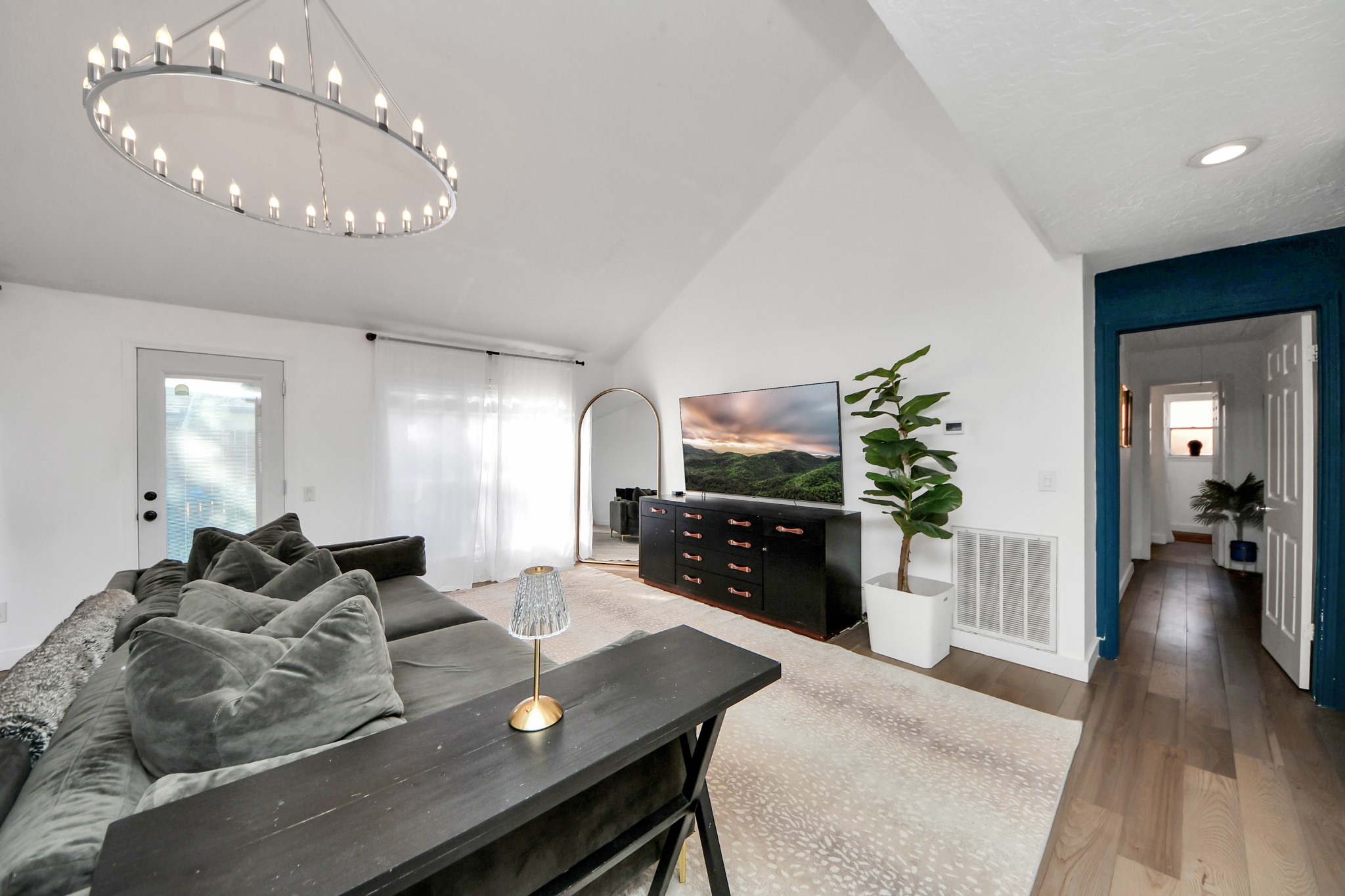 15015 Margeson Street Houston, TX 77084 - Photo 7 of 21 a living room with furniture a large window and a flat screen tv