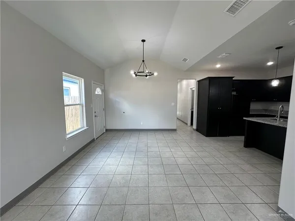 a view of a kitchen with a sink and a refrigerator
