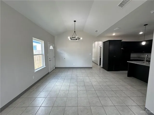 a view of a kitchen with a sink and a refrigerator