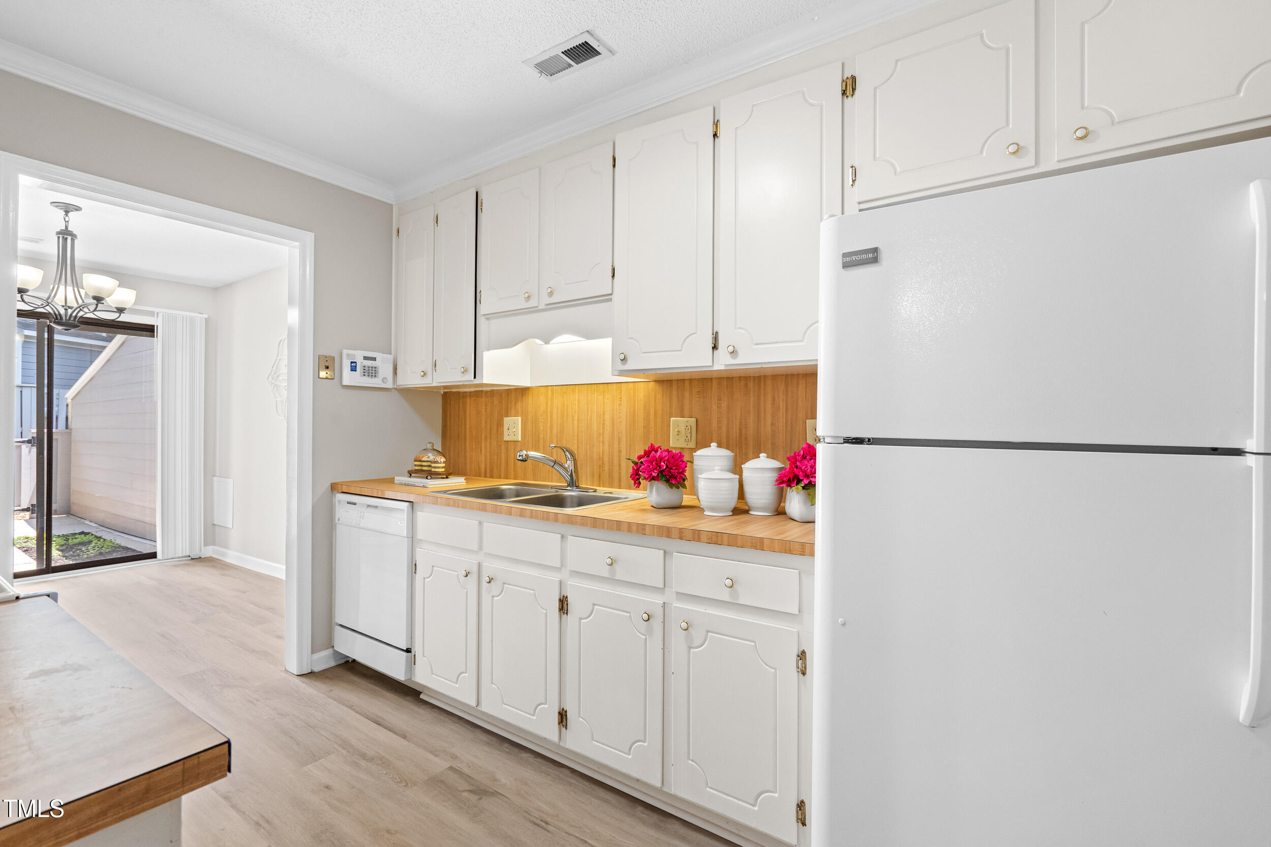 232 Clancy Circle Cary, NC 27511 - Photo 5 of 14 a kitchen with white cabinets and white appliances