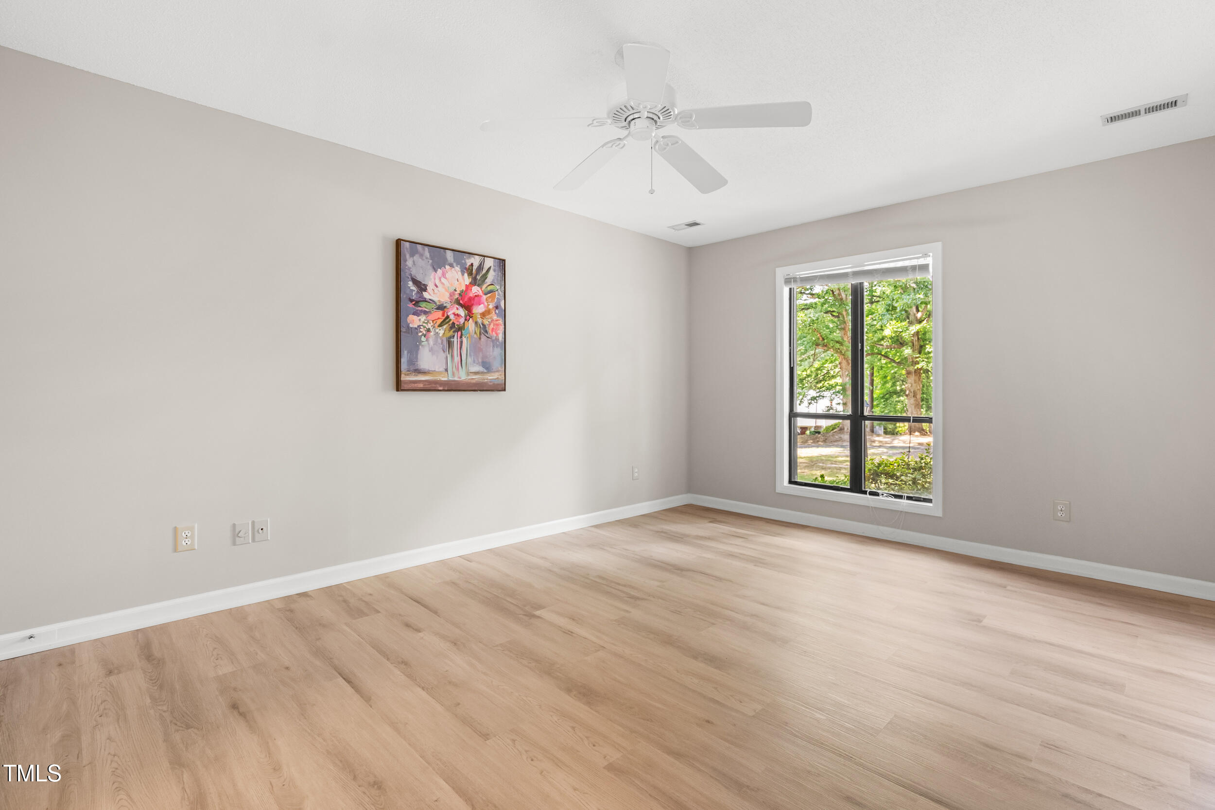 232 Clancy Circle Cary, NC 27511 - Photo 10 of 14 an empty room with windows and fan