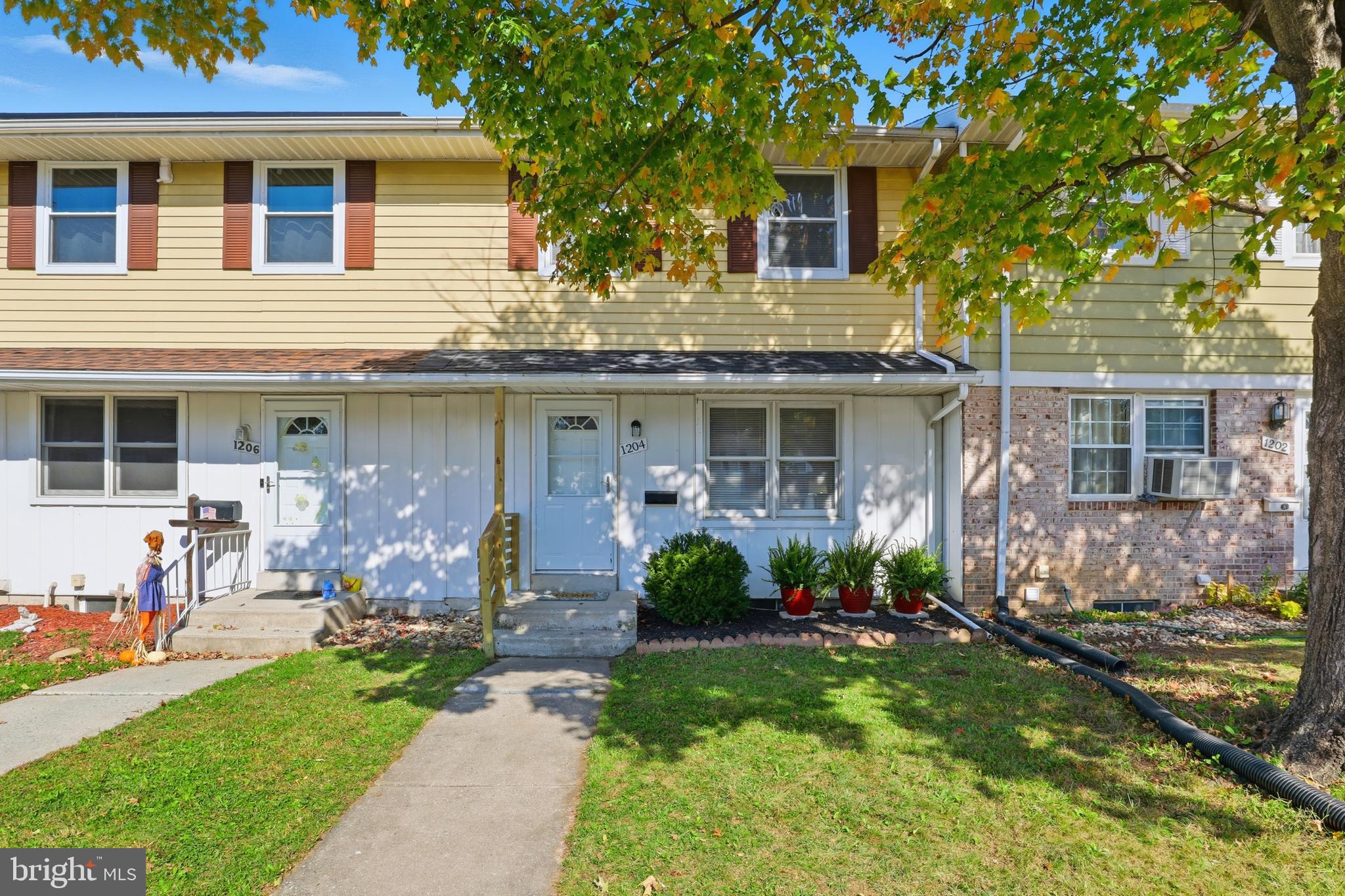 a front view of a house with a yard and outdoor seating